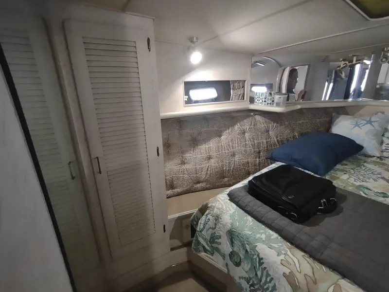 Slide: The Image of 1988 Tollycraft 34 Sport Sedan cabin interior with bed and storage. - 15