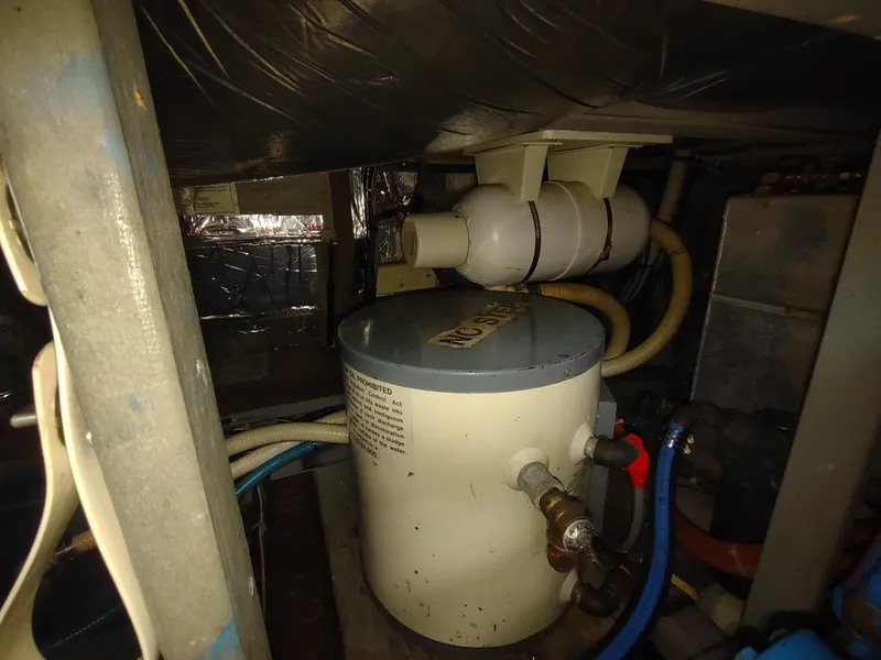 Slide: The Image of Engine room of a 1988 Tollycraft 34 Sport Sedan with water heater and plumbing. - 39