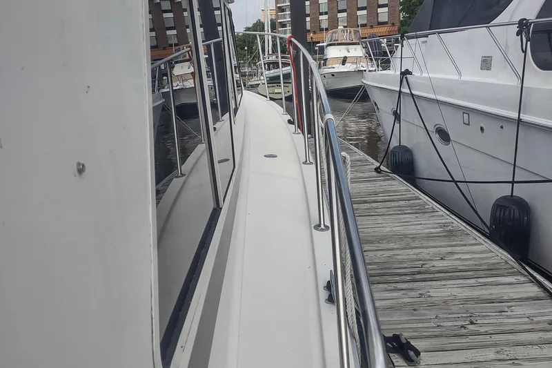Slide: The Image of 1988 Tollycraft 34 Sport Sedan docked at a marina. - 46
