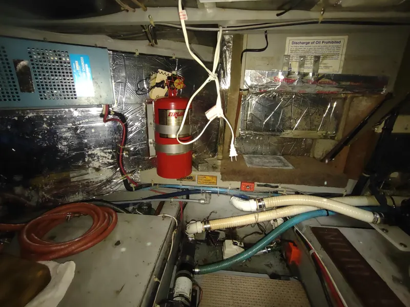 Slide: The Image of Engine room of 1988 Tollycraft 34 Sport Sedan with fire extinguisher and various equipment. - 38