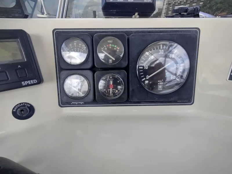 Slide: The Image of Dashboard of a 1988 Tollycraft 34 Sport Sedan boat with gauges and controls. - 33