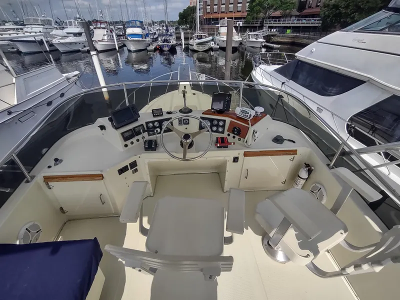 Slide: The Image of 1988 Tollycraft 34 Sport Sedan boat helm with marina view. - 28