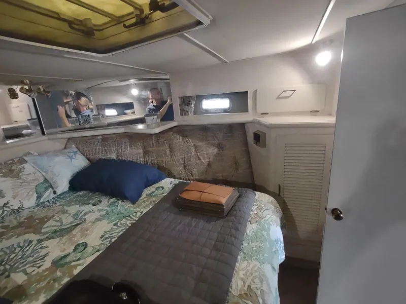 Slide: The Image of Cozy bedroom interior of 1988 Tollycraft 34 Sport Sedan yacht with bed and storage. - 16