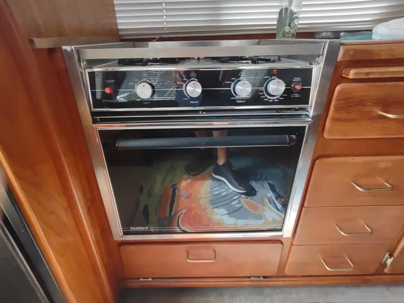 Slide: The Image of 1988 Tollycraft 34 Sport Sedan kitchen with a Seaward oven and stove. - 13