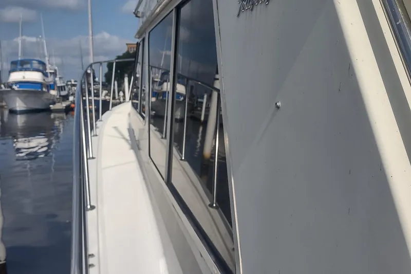 Slide: The Image of 1988 Tollycraft 34 Sport Sedan docked at a marina. - 47