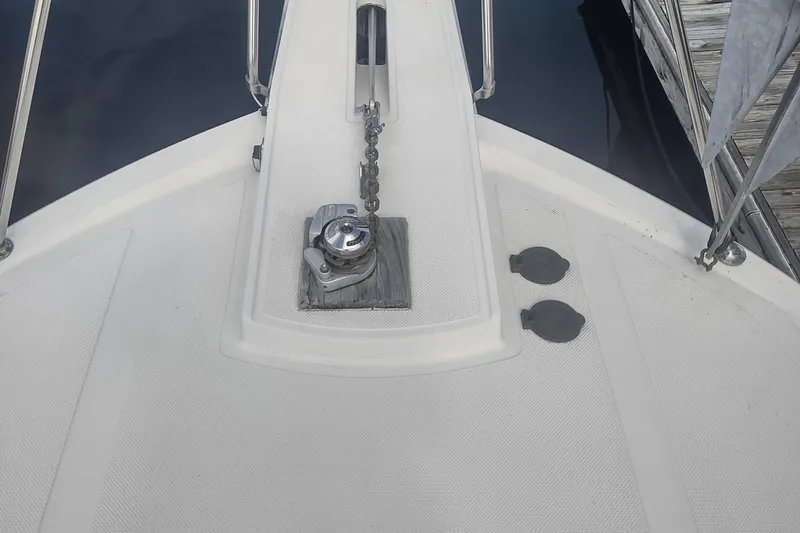 Slide: The Image of Bow deck of 1988 Tollycraft 34 Sport Sedan with anchor chain and winch. - 49