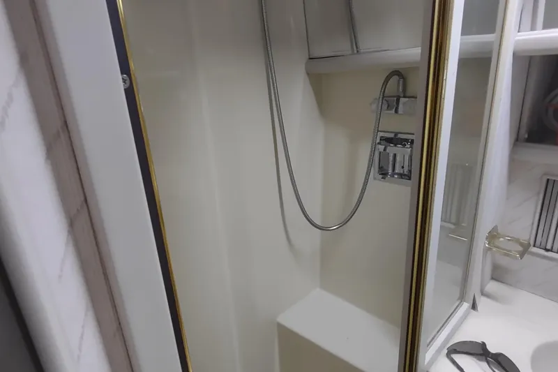 Slide: The Image of 1988 Tollycraft 34 Sport Sedan bathroom shower with handheld showerhead. - 20