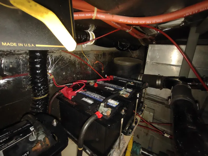 Slide: The Image of 1988 Tollycraft 34 Sport Sedan engine room with batteries and wiring. - 42