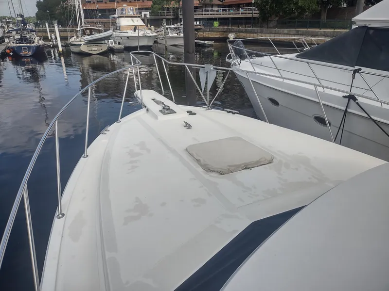 Slide: The Image of 1988 Tollycraft 34 Sport Sedan yacht docked at a marina. - 48