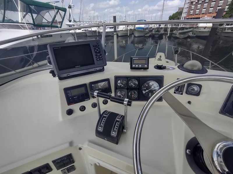 Slide: The Image of Helm of 1988 Tollycraft 34 Sport Sedan with navigation equipment and marina view. - 30