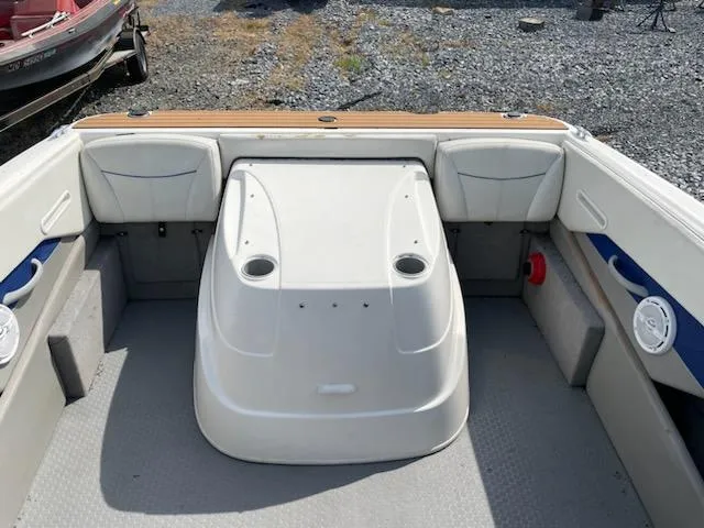 Slide: The Image of 2007 Bayliner Discovery 215 boat interior with seating and storage compartments. - 12