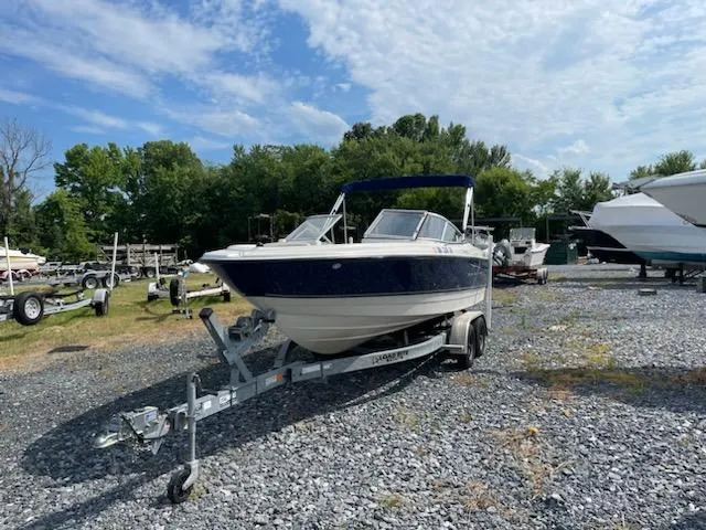 Slide: The Image of 2007 Bayliner Discovery 215 boat on a trailer in a boatyard. - 18