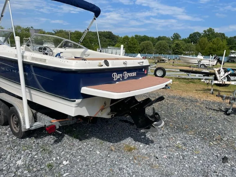 Slide: The Image of 2007 Bayliner Discovery 215 boat named Bay Breeze on a trailer in a boatyard. - 24