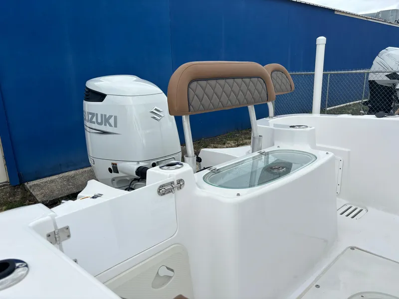 Slide: The Image of 2024 Polar 220 boat with Suzuki outboard motor and cushioned seating. - 10