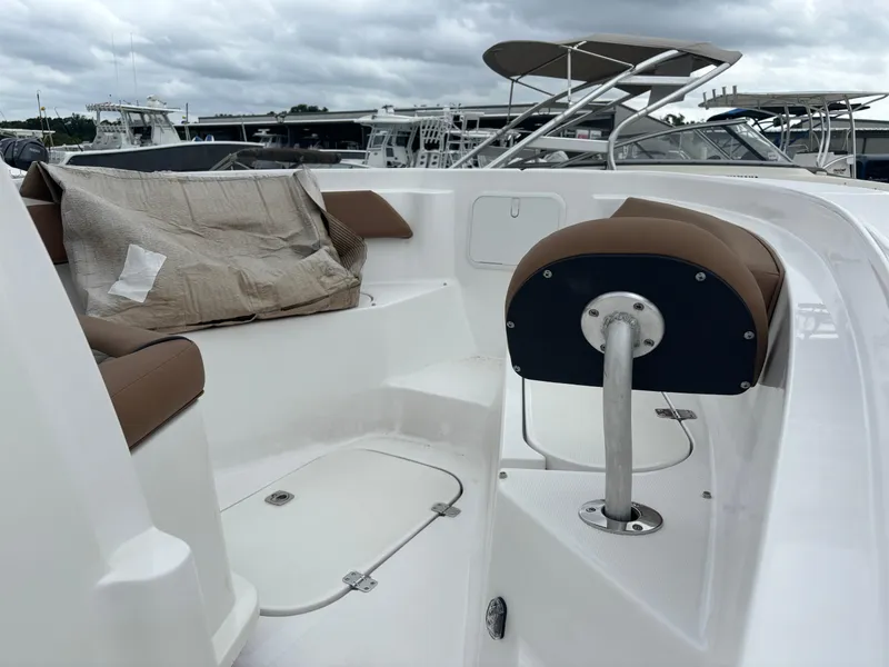 Slide: The Image of 2024 Polar 220 boat interior with brown seating and storage compartments. - 11