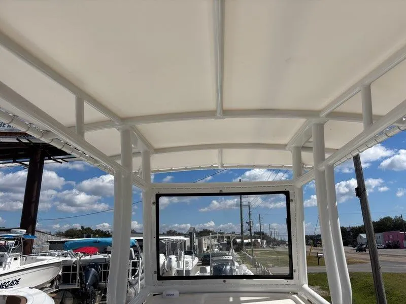 Slide: The Image of 2024 Polar 220 boat interior with canopy, showcasing clear skies and marina view. - 6