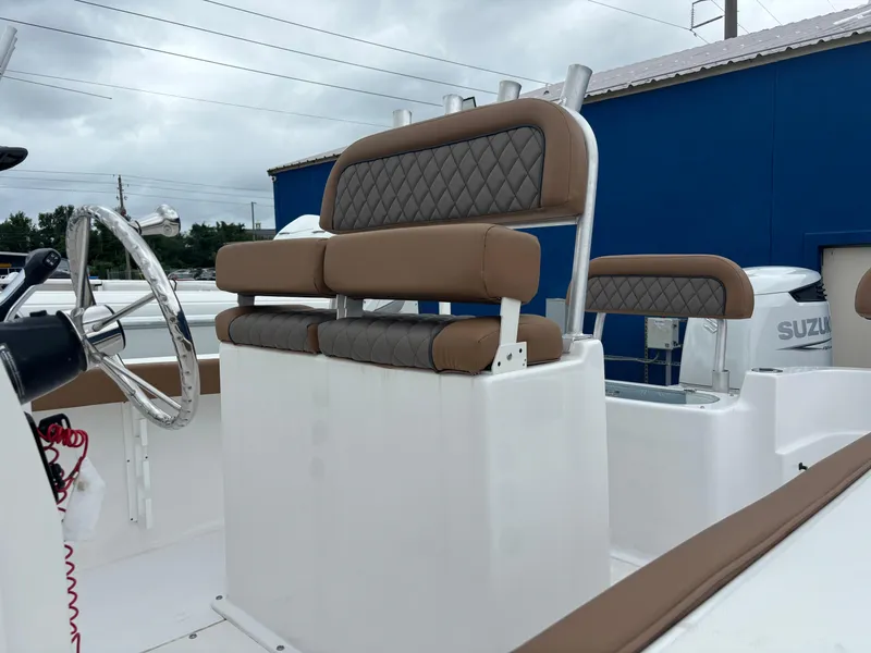 Slide: The Image of 2024 Polar 220 boat interior with brown and gray cushioned seating. - 9