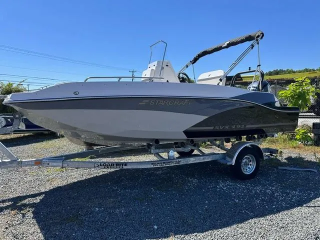 The Image of 2025 Starcraft SVX 191 OB CC boat on trailer under clear blue sky. - 0