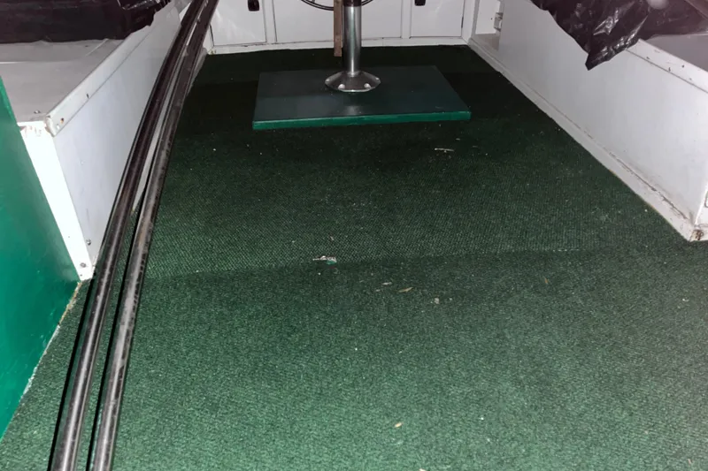 Slide: The Image of Interior of a 1982 Monk 40 boat with green carpet flooring. - 36