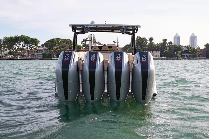 Slide: The Image of 2024 Midnight Express 37' Open boat with quad outboard engines on the water. - 10