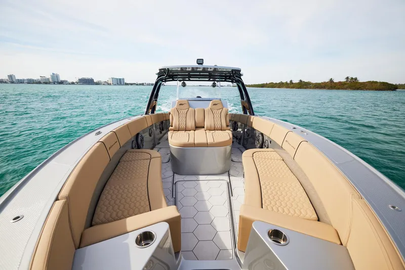 Slide: The Image of 2024 Midnight Express 37' Open boat with luxurious seating on calm waters. - 12