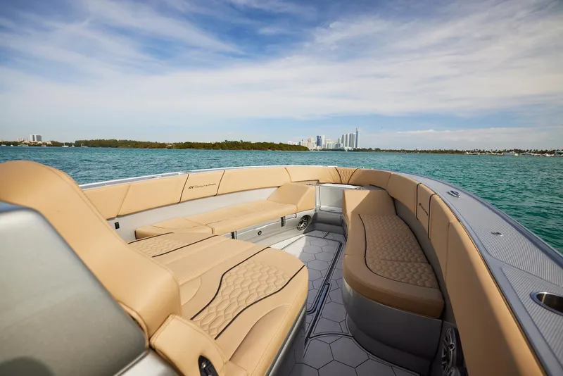Slide: The Image of 2024 Midnight Express 37' Open boat with luxurious seating on a sunny day. - 15