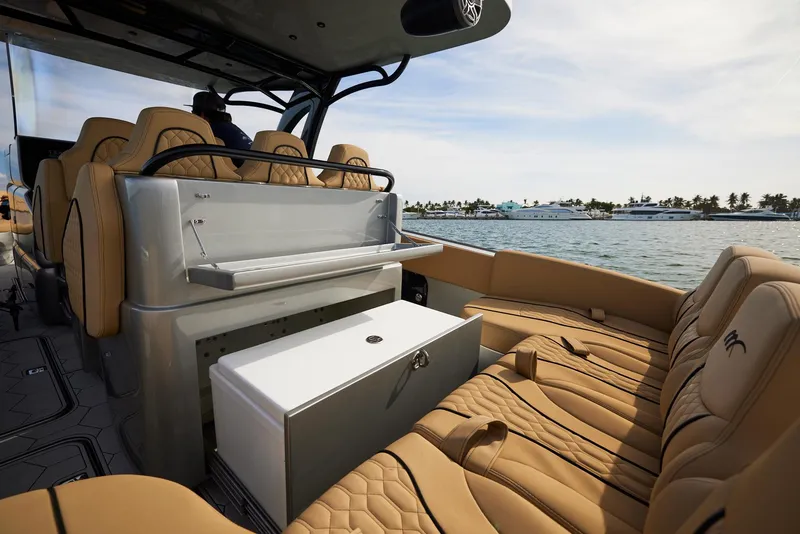 Slide: The Image of 2024 Midnight Express 37' Open boat interior with tan seating and ocean view. - 21