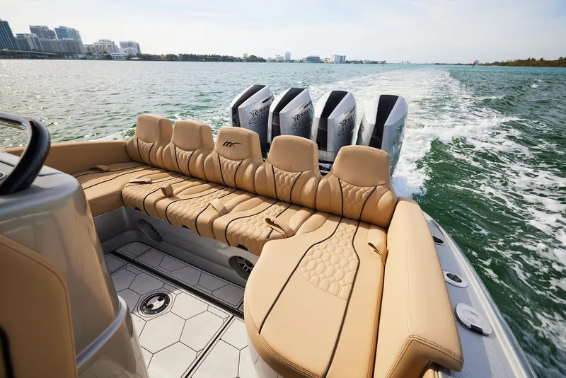 Slide: The Image of 2024 Midnight Express 37' Open boat with luxurious seating and powerful engines on the water. - 22