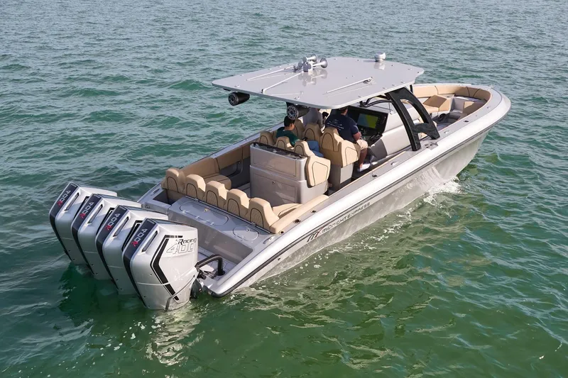 Slide: The Image of 2024 Midnight Express 37' Open boat cruising on water with triple outboard engines. - 8