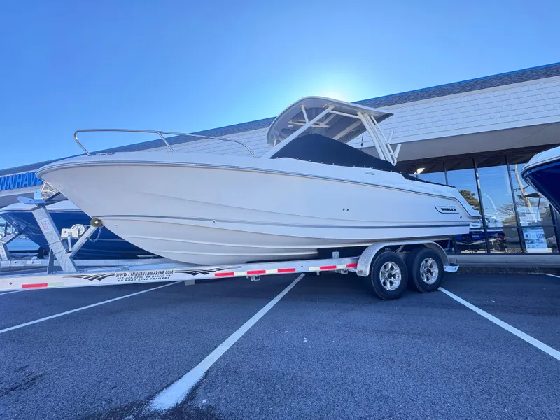 Slide: The Image of 2024 Boston Whaler 240 Vantage boat on trailer in parking lot. - 0