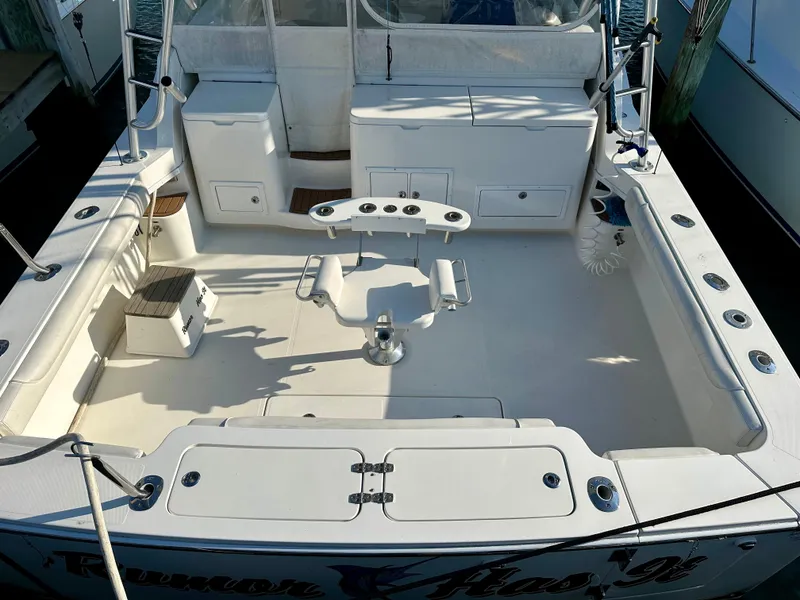 Slide: The Image of 2014 Albemarle 360 Express Fisherman boat deck with fishing chair and storage compartments. - 2