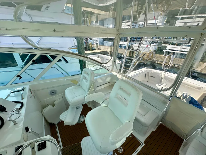 Slide: The Image of 2014 Albemarle 360 Express Fisherman cockpit with white seating and clear enclosure. - 22