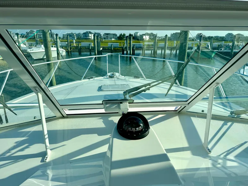 Slide: The Image of View from 2014 Albemarle 360 Express Fisherman cockpit, showing marina and compass. - 25