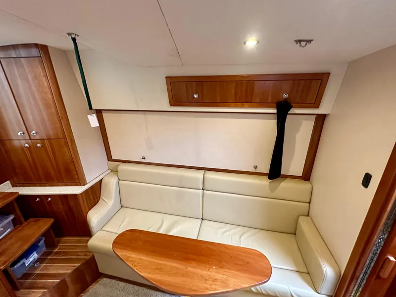 Slide: The Image of 2014 Albemarle 360 Express Fisherman interior with beige seating and wooden cabinetry. - 30