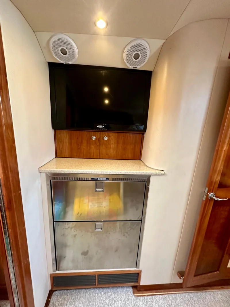 Slide: The Image of 2014 Albemarle 360 Express Fisherman interior with TV, speakers, and stainless steel fridge. - 32