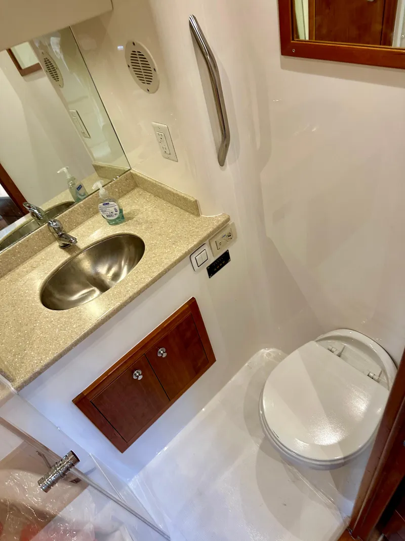 Slide: The Image of 2014 Albemarle 360 Express Fisherman bathroom with sink, toilet, and mirror. - 34