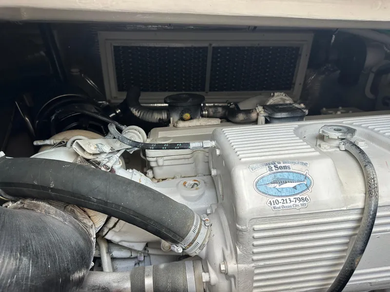 Slide: The Image of Engine compartment of a 2014 Albemarle 360 Express Fisherman boat, featuring hoses and components. - 41