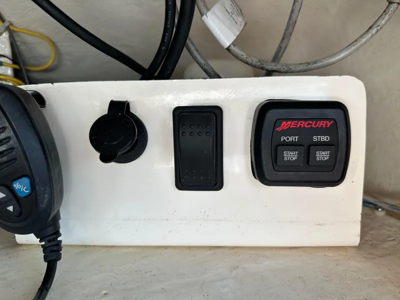 Slide: The Image of Control panel of a 2014 Albemarle 360 Express Fisherman boat with Mercury start-stop buttons. - 48