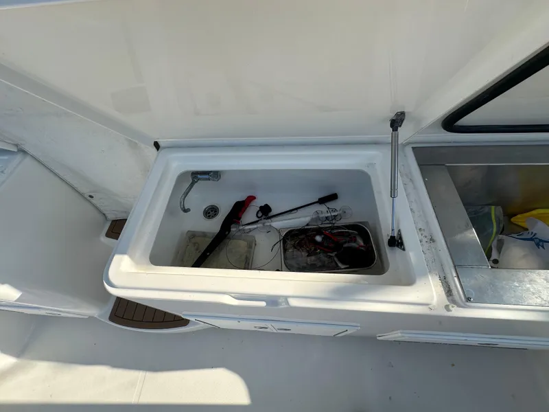 Slide: The Image of Open storage compartment on 2014 Albemarle 360 Express Fisherman boat with tools and equipment. - 8