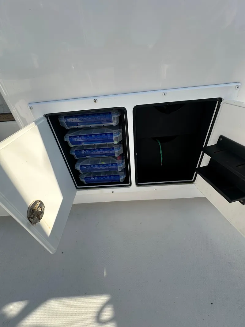 Slide: The Image of Storage compartment on a 2014 Albemarle 360 Express Fisherman boat with organized tackle boxes. - 9