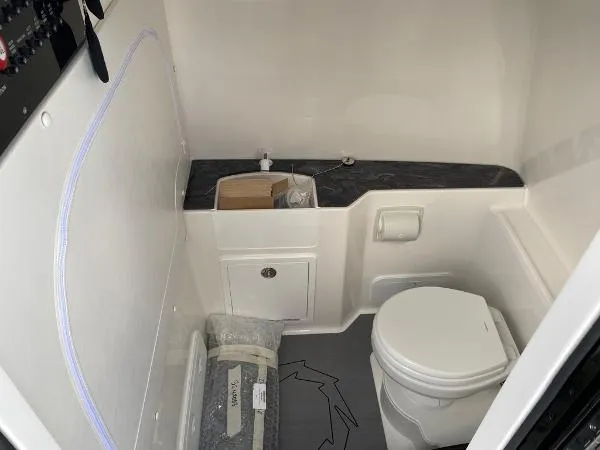 Slide: The Image of 2025 Fountain 32 NX boat docked by waterfront homes. - 16