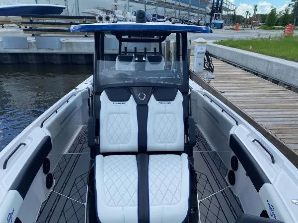 Slide: The Image of 2025 Fountain 32 NX boat interior with cushioned seating and marine speakers. - 20