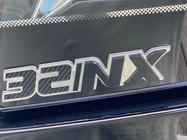 Slide: The Image of 2025 Fountain 32 NX boat docked at a marina. - 4