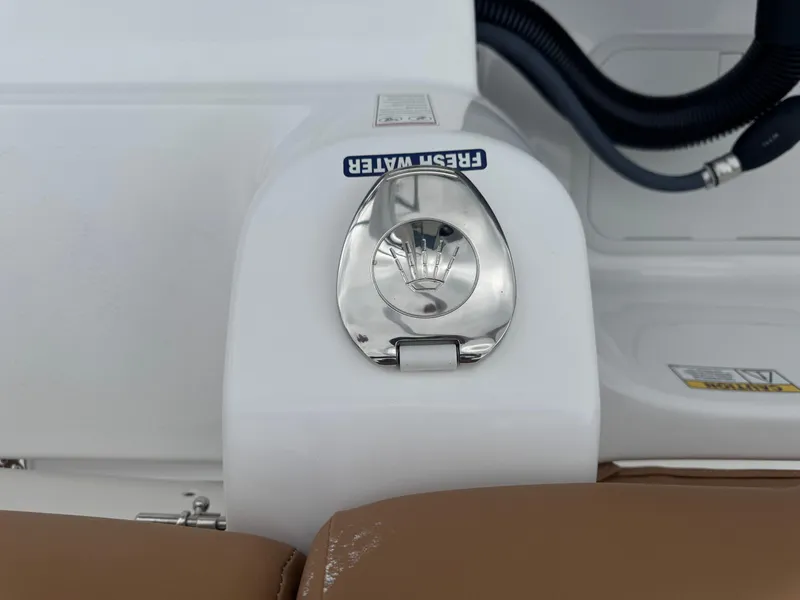 Slide: The Image of 2024 NauticStar 212 Legacy boat, fresh water access, white and brown seating. - 14