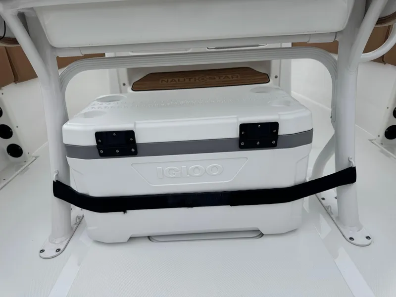 Slide: The Image of 2024 NauticStar 212 Legacy boat with Igloo cooler secured under seat. - 16