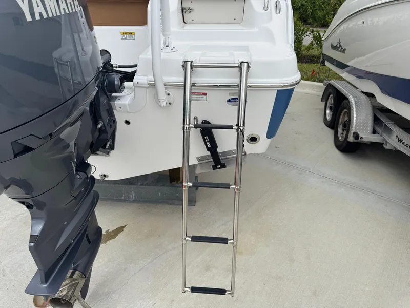 Slide: The Image of 2024 NauticStar 212 Legacy boat with Yamaha outboard and stainless steel ladder. - 19