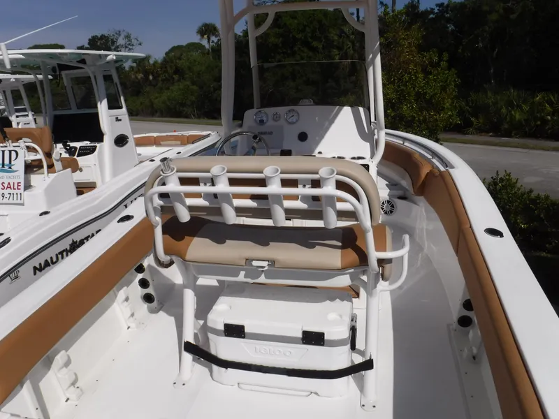 Slide: The Image of 2024 NauticStar 212 Legacy boat interior with seating and rod holders. - 3