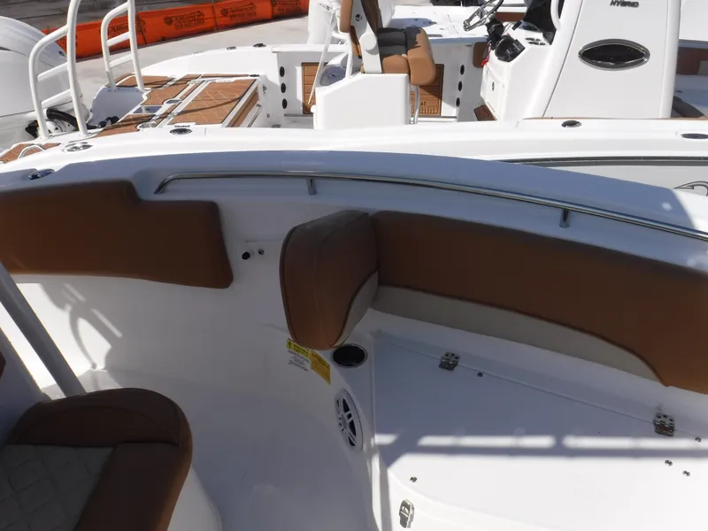 Slide: The Image of 2024 NauticStar 212 Legacy boat interior with brown seating and white deck. - 6