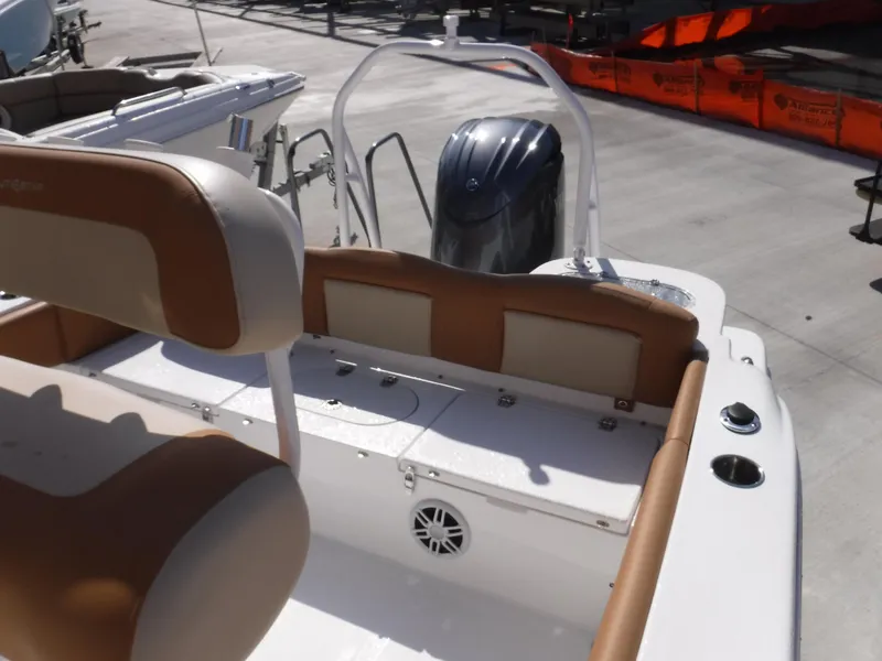 Slide: The Image of 2024 NauticStar 212 Legacy boat interior with tan seating and outboard motor. - 7