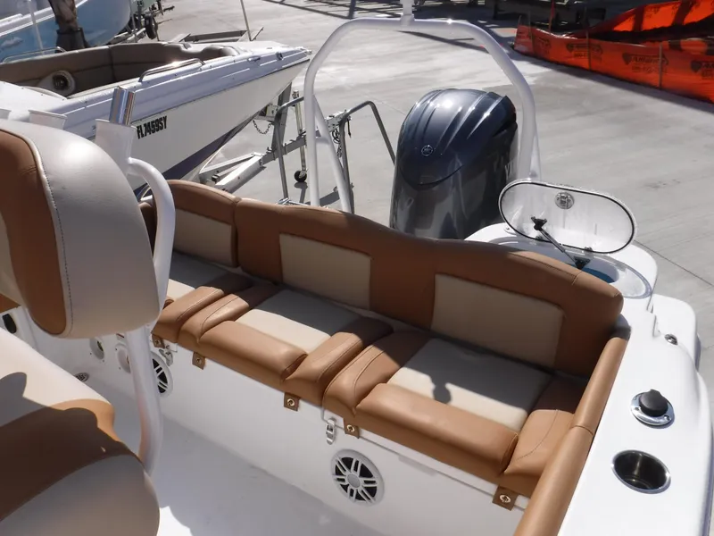 Slide: The Image of 2024 NauticStar 212 Legacy boat interior with tan seating and modern design. - 9